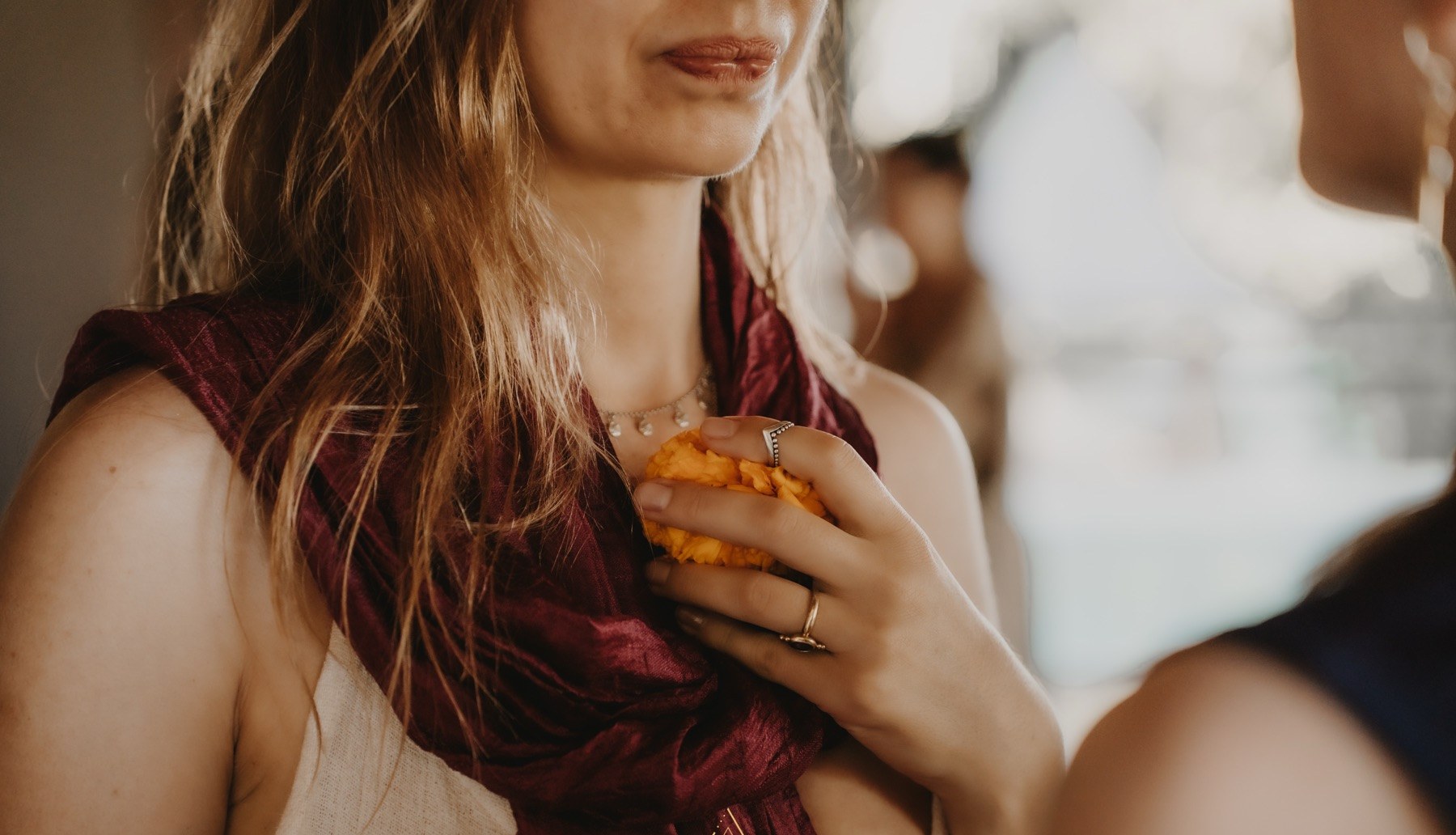 A marigold held to the heart at a Medicine Within ceremony in Amsterdam